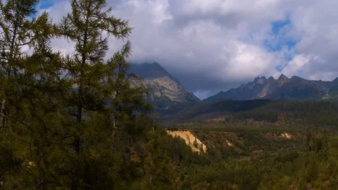 Drone flying into the valley between the trees in the mountains 4k HDR H264 Stock Footage 88270347