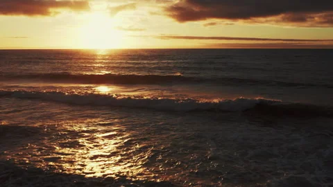 Drone is flying to the water surface of the ocean during sunset.  Beautiful.. Stock Footage 302797493