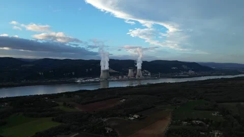 Drone flyover above Cruas nuclear plant by Rhone River in France aerial view Video stock 333772244