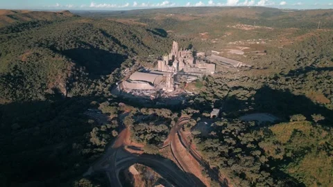 Drone flyover above rare earth processing plant in mountainous terrain near Stock Footage 336398447