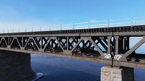 Drone Flyover and Close-Up of Historic Railroad Bridge over Saint-Laurent River Stock Footage 307720575