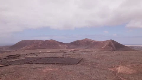 Drone Flyover of Arid Volcanic Terrain Near Calderon Hondo, Fuerteventura Stock Footage 309027739
