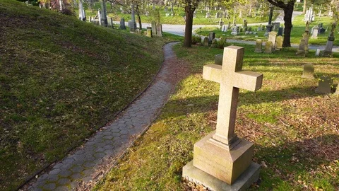 Drone flyover cross grave marker Greenwood Cemetery Stock Footage 129274275