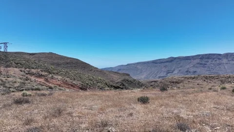 Drone Flyover of Dry Mountain Vegetation Under Blue Sky – Gran Canaria Stock Footage 310147246