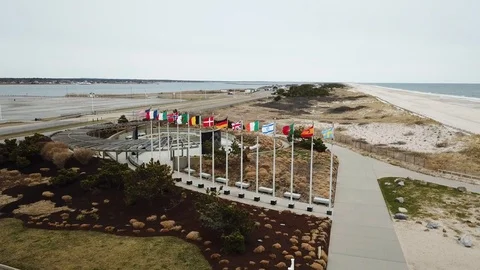 Drone Flyover Flight 800 memoerial American and international flags waving Stock Footage 106042046