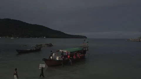 Drone flyover island beach unloading boat WS Cambodia Stock Footage 140280646