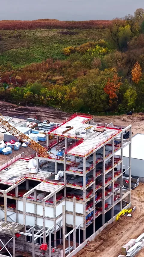 Drone Flyover of Large Rural Construction Site Beside River in European Stockbeeldmateriaal 337010957