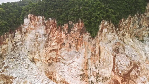 Drone flyover of limestone quarry, mogotes scraped by machinery, Malaysia Stock Footage 323349697