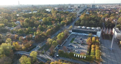 Drone flyover past Iglica spire and autumn trees in Wrocław Stock Footage 346619826