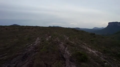 Drone Flyover of a Remote Mountainous Landscape with a Winding Path 스톡 동영상 332728092