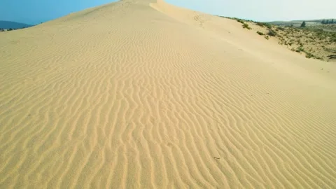 Drone flyover of rippled sand patterns in the desert Stock Footage 296263979