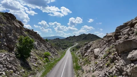 Drone flyover of road through rock in East Kazakhstan Stock Footage 317512011