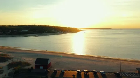Drone Flyover of Shoreline Parking Lot at Sunset - Centerport NY Stock Footage 308337429