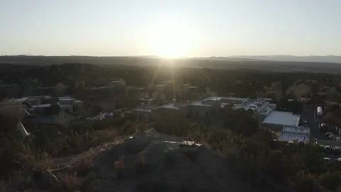 Drone flyover shot from grassy mountain to small town Video stock 167660236