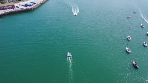 Drone Flyover of Small Boat and Approaching Jet Ski in Harbour 4k Stock Footage 320946497