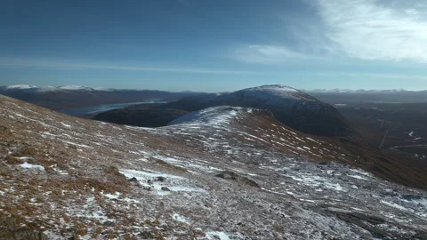 Drone flyover of snowy mountain slope in the Scottish Highlands Видео 335983295