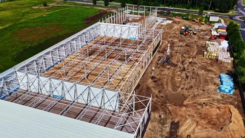 Drone Flyover of Steel Warehouse Frame and Construction Site Stock Footage 341545084