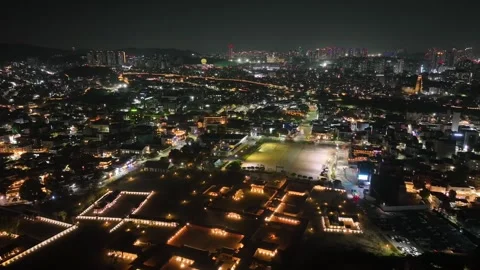 Drone flyover of Suwon traditional complex and vibrant night city streets Stock Footage 313641370
