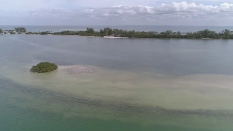 Drone flyover tiny island towards causeway Video stock 86215732