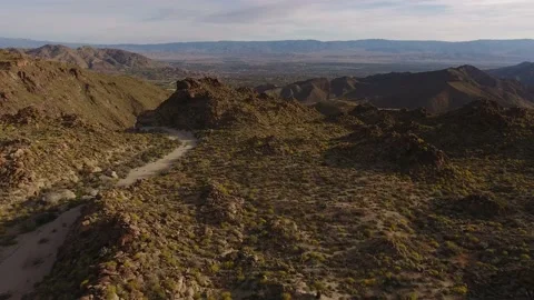 Drone Flyover Toward Rugged Mountain in California Desert Springtime Stock Footage 146755466