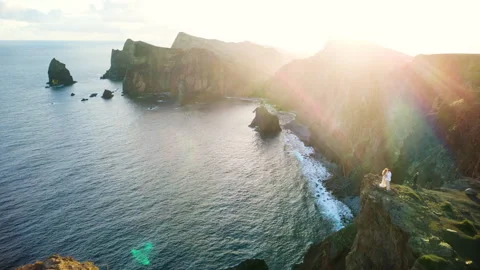 Drone flyover of wedding couple at Ponta do Rosto cliff at sunrise, Madeira Vídeos de archivo 328639277