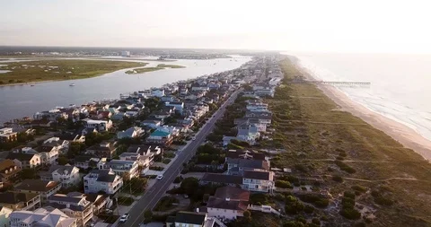 Drone flyover Wrightsville Beach North Carolina at sunset Stock Footage
