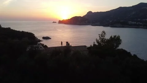 Drone Flypast of Man on Rooftop at Sunset, Liapades, Corfu Stock Footage 337732212