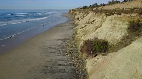 Drone flys along cliffs over ocean rotating to ocean Stock Footage 71133724