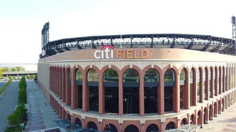 Drone flys up and over Citifield exterior wall Stock Footage 131559056