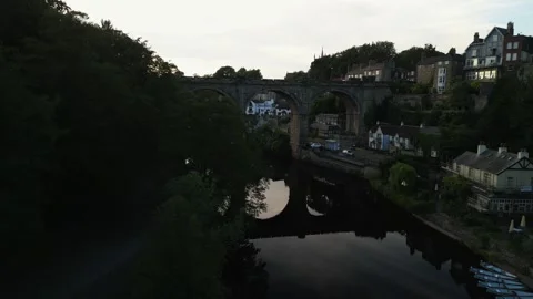 Drone flys around waterfront trees next to the river nidd to reveal a large Video stock 321440218