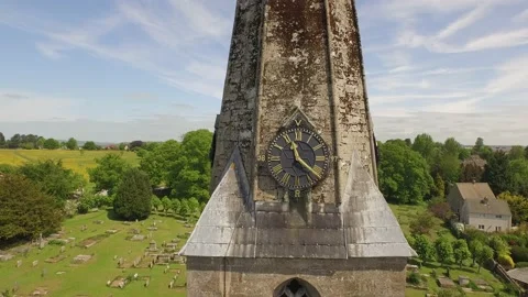Drone flys away from closeup clock on church steeple Stock Footage 135826342