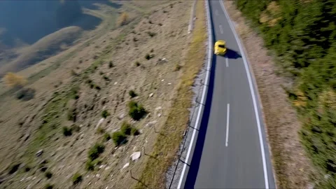 Drone flys down road and turns to Exotic sportscar Stock Footage 167943152