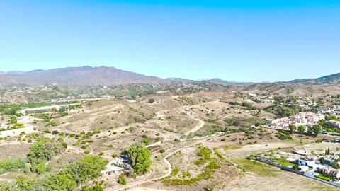 Drone flys forward to show a beautiful landscape at morning light, with bright Stock Footage 346113694