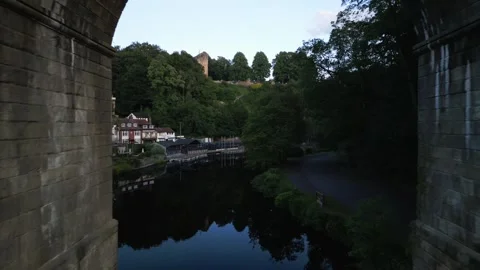 Drone flys inbetween the large stone pillars holding up the Knaresborough Stock-Footage 321440232