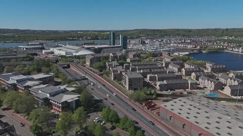 Drone flys over dual-carriageway towards Chatham Marina Waterfront [4K] Stock Footage 335820553