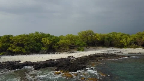 Drone flys over ocean towards sandy beach 스톡 동영상 102033387