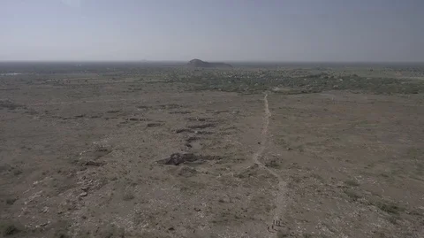 Drone flys over school in the middle of nowhere, some students outside Stock Footage