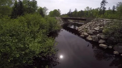 Drone flys under bridge with stream (aerial) Stock Footage 51735323