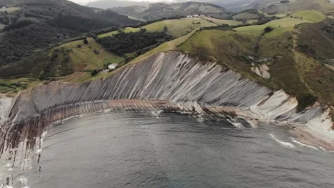 Drone flysch sea stack rock lines formation beach stones Stock Footage 221572362