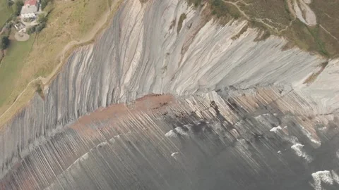 Drone flysch sea stack rock lines formation beach stones Stock Footage 221572412