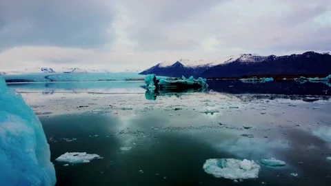 Drone Flythrough Past Blue Iceberg in Jökulsárlón Glacier Lagoon, Iceland Stock Footage 292576255