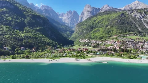 Drone Focus on the White Sand Beach and Waterfront Park of Molveno Italy Vídeo Stock 338010551