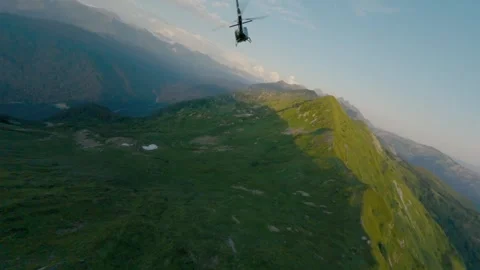 Drone follow to helicopter at sunset mountain valley ridge aerial view Stock Footage 330076533