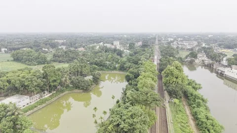 Drone Follow Shot of a Fast Moving Passenger Train Through Rural Landscape Stock Footage 338007875