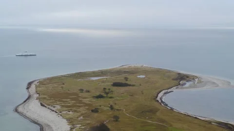 Drone follow small ferry passing a small island in Denmark Stock Footage 314213542