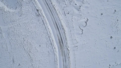 Drone Following an empty road in the snow Stock-Footage 89350530