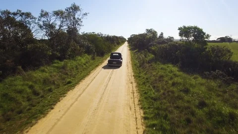 Drone following old car driving done dirt road in country Victoria. Stock Footage 87693585