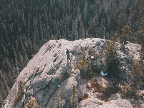 Drone following person to edge of cliff Stock Footage