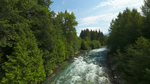 Drone following a rushing mountain river upstream Stock Footage 342761904