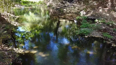 Drone following stream to waterfall at Lomas de Barbudal Biological Reserve Stock Footage 90924401
